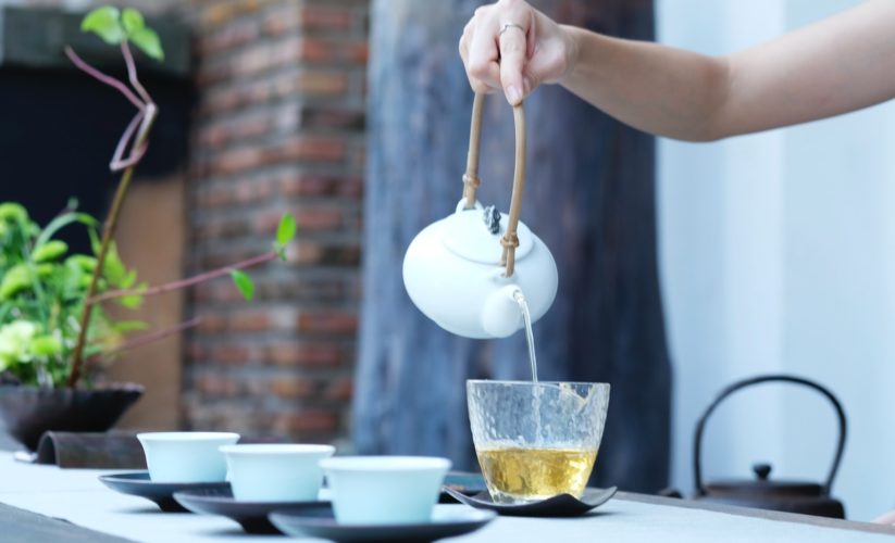 person holding kettle